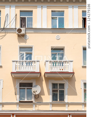 The facade of a modern building in which people The facade of a modern building in which people 124279186