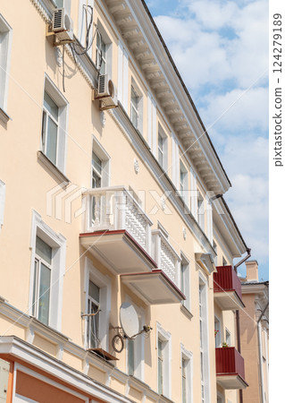 The facade of a modern building in which people The facade of a modern building in which people 124279189