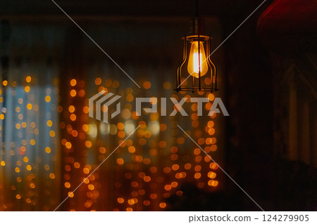 An old yellow -light incandescent lamp with a An old yellow -light incandescent lamp with a 124279905