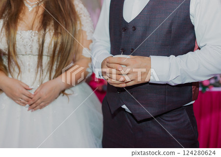 The newlyweds at the wedding holds a candle in The newlyweds at the wedding holds a candle in 124280624