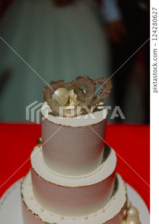 A beautiful handmade wedding cake you stands on a 124280627