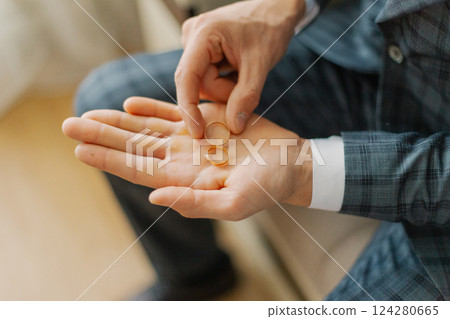 A young groom on his wedding day holds wedding 124280665