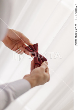 The groom on his wedding day holds in his hands ah 124280673