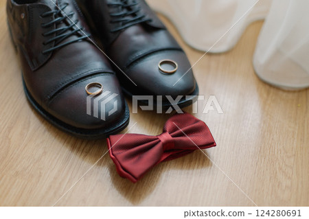 The groom's new black shoes on the floor near a The groom's new black shoes on the floor near a 124280691