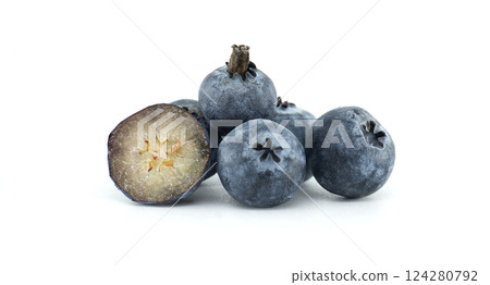 A small pile of fresh blueberries with one halved, showcasing its texture and vibrant color. 124280792
