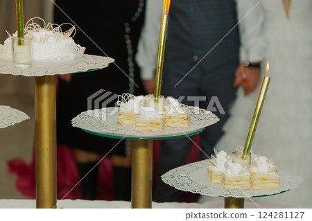 Beautiful wedding cake at a wedding with glowing Beautiful wedding cake at a wedding with glowing 124281127