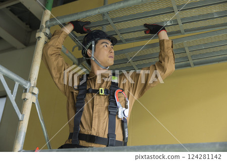 A man working at a construction site A man working at a construction site 124281142