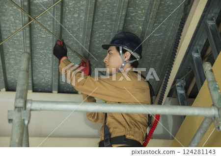 A man working at a construction site A man working at a construction site 124281143