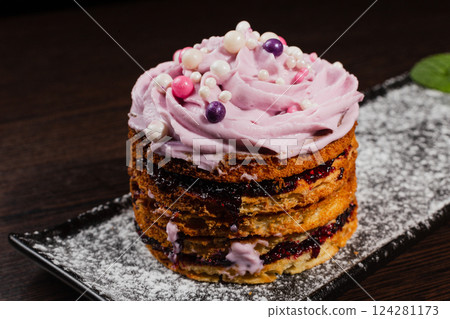 Appetizing fresh dessert cake on a black plate Appetizing fresh dessert cake on a black plate 124281173