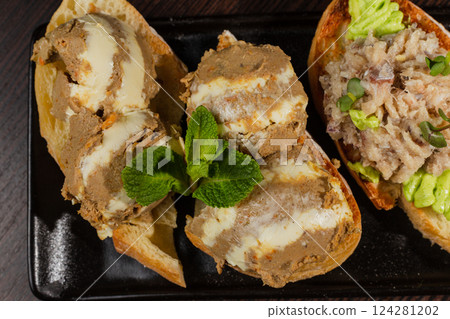 Three types of bruschetta on the table on a black Three types of bruschetta on the table on a black 124281202