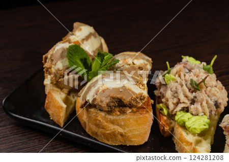 Three types of bruschetta on the table on a black Three types of bruschetta on the table on a black 124281208
