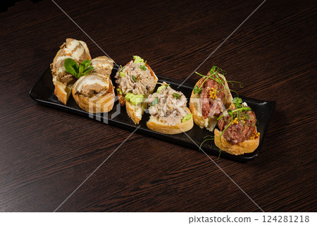 Three types of bruschetta on a table on a black Three types of bruschetta on a table on a black 124281218