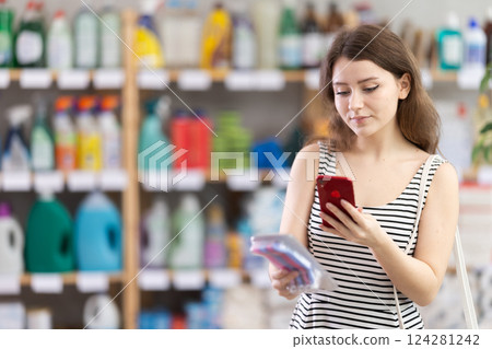 Woman scanning the barcode of a package with razors 124281242