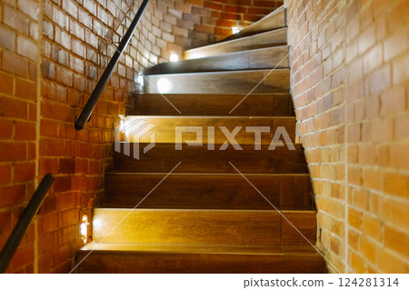 A beautiful wooden staircase with illuminated 124281314