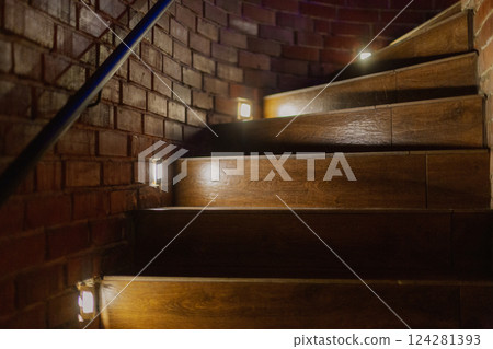 A beautiful wooden staircase with illuminated 124281393