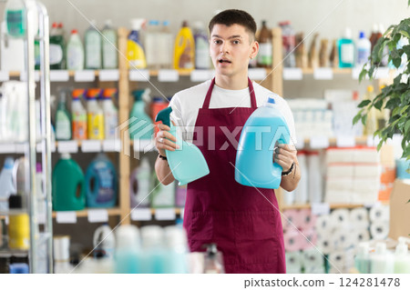 Man seller offers laundry detergent and spray Man seller offers laundry detergent and spray 124281478