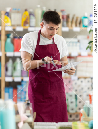 Anxious man seller with checklist in store 124281539