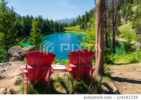 Tranquil Turquoise Lake with Red Adirondack Chairs, Valley of the Five Lakes, Jasper National Park, Alberta, Canada. Tranquil Turquoise Lake with Red Adirondack Chairs, Valley of the Five Lakes, Jasper National Park, Alberta, Canada. 124281729