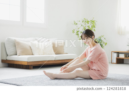 A woman in pajamas doing body care A woman in pajamas doing body care 124281818