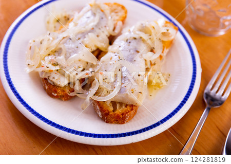 Marinated herring and onion sandwich served on plate 124281819