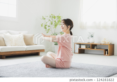 A woman in pajamas doing body care 124281822