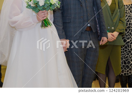 Newlywed holding hands at the wedding ceremony Newlywed holding hands at the wedding ceremony 124281969