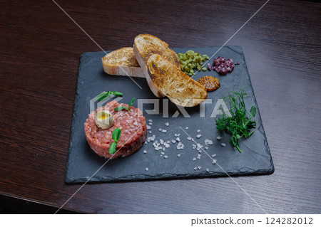 Beef tartare. Cold appetizer of raw marinated meat 124282012