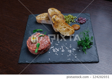 Beef tartare. Cold appetizer of raw marinated meat 124282031