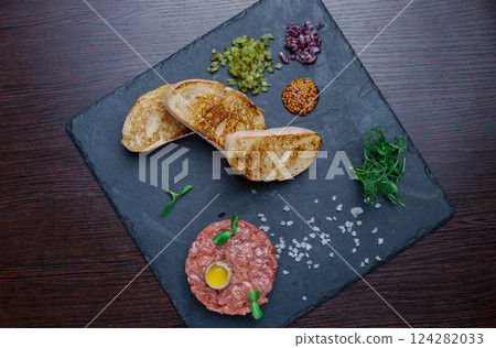 Beef tartare. Cold appetizer of raw marinated meat Beef tartare. Cold appetizer of raw marinated meat 124282033
