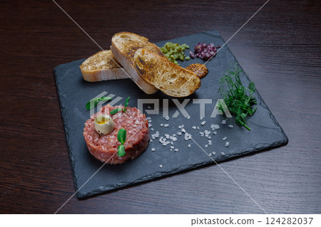 Beef tartare. Cold appetizer of raw marinated meat 124282037