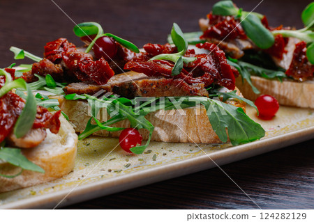 Appetizing sandwiches with meat, greens and 124282129