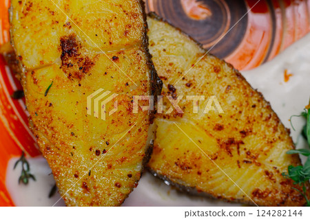 Grilled fresh red fish lies on a plate along with Grilled fresh red fish lies on a plate along with 124282144