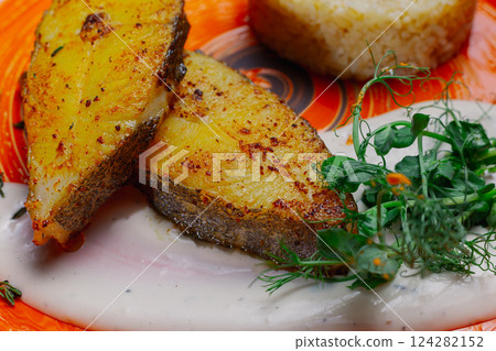 Grilled fresh red fish lies on a plate along with 124282152