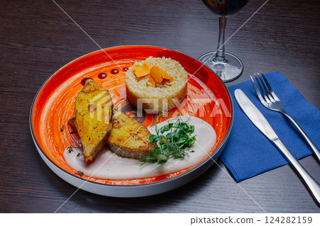Grilled fresh red fish lies on a plate along with 124282159