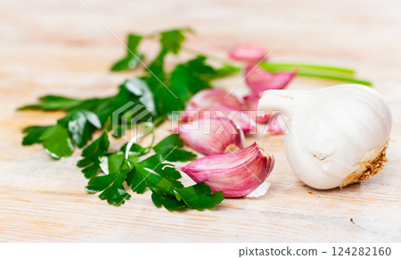 Garlic and parsley on the cutting board Garlic and parsley on the cutting board 124282160