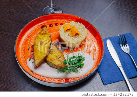 Grilled fresh red fish lies on a plate along with 124282172