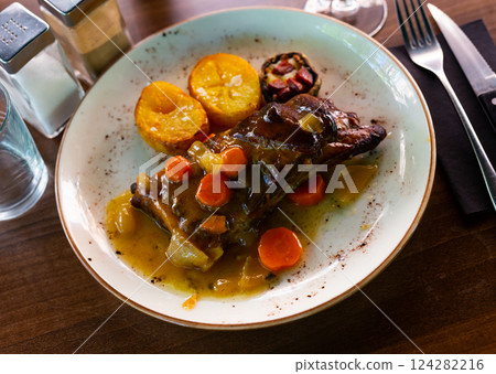 Grilled ribs with baked potatoes and gravy Grilled ribs with baked potatoes and gravy 124282216