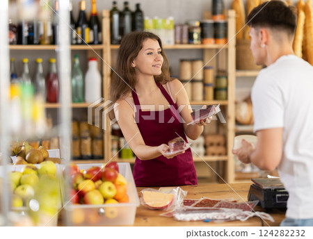 Grocery clerk helping customer to choose packaged deli meats Grocery clerk helping customer to choose packaged deli meats 124282232