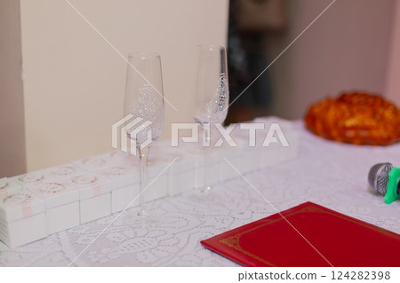 two beautiful wedding glasses on a white sheet at 124282398