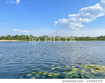 power line across the river in summer against the 124282470