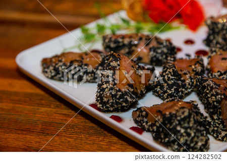 Grilled red fish meat with sesame seeds. A plate Grilled red fish meat with sesame seeds. A plate 124282502
