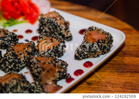Grilled red fish meat with sesame seeds. A plate Grilled red fish meat with sesame seeds. A plate 124282509