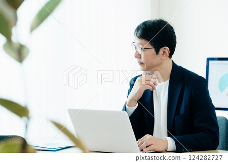 Businessman operating a personal computer Businessman operating a personal computer 124282727