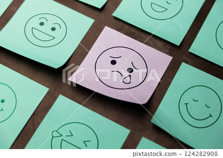Mind, Mental Health Concept. Mood and Emotion on Sticky Note. Sadness Cartoon Emoticon Face at the center, surrounded by another happy faces 124282908