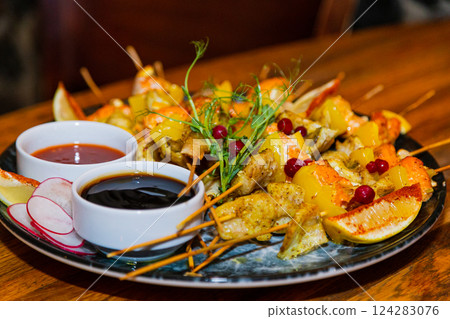 Shish kebab from seafood and red fish on wooden Shish kebab from seafood and red fish on wooden 124283076