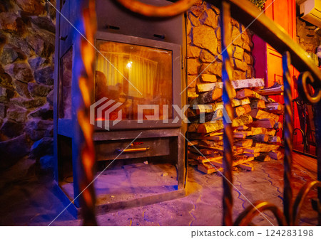 Beautiful antique fireplace with wood for kindling Beautiful antique fireplace with wood for kindling 124283198