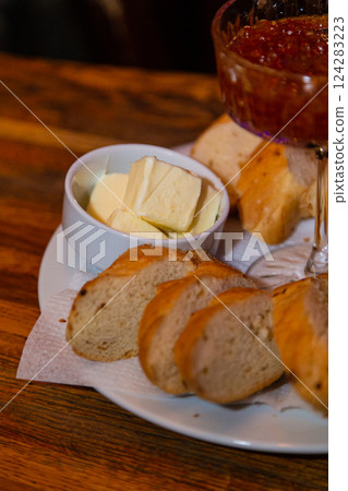 Glass bowl with salmon caviar on a tray with bread Glass bowl with salmon caviar on a tray with bread 124283223