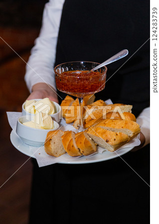 A glass bowl with salmon caviar on a tray with A glass bowl with salmon caviar on a tray with 124283739