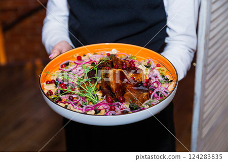 Stewed pork with vegetables on a plate in the Stewed pork with vegetables on a plate in the 124283835