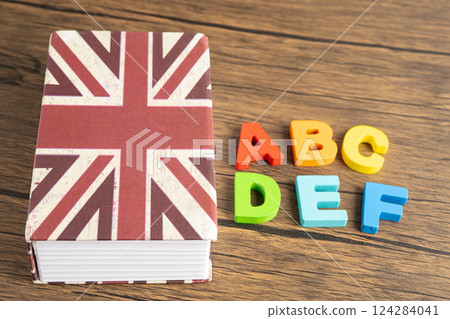 Word English on book with United Kingdom flag, learning English language courses concept. 124284041